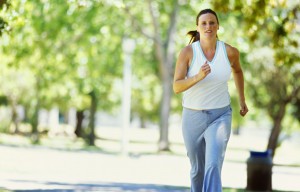 portrait of a mid adult woman jogging in a park